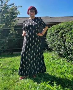 a woman standing on top of a lush green field