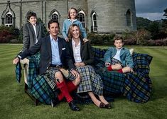 a group of people sitting on couches in front of a castle