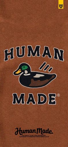 a brown shirt with a duck on the front and words human made written in black