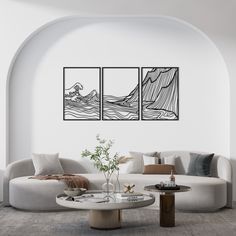 a living room with three paintings on the wall