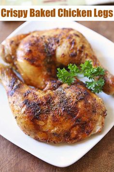 two pieces of chicken on a white plate with parsley sprig in the middle