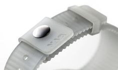 a white watch band with a metal button on it