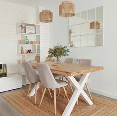 a dining room table with chairs and a rug