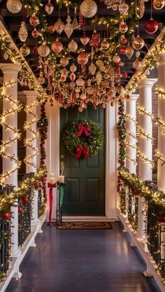 a hallway decorated for christmas with lights and ornaments hanging from the ceiling over the door