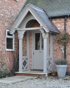 a small building with a potted plant next to it and the door is open