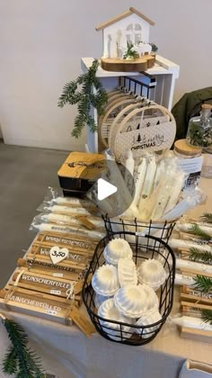 a table topped with lots of cheeses and other items on top of a table