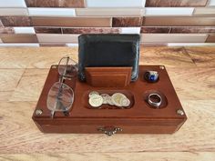 a wooden box with some glasses and other items