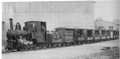 an old black and white photo of people standing on the side of a train engine