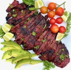 steak, tomatoes and lettuce on a white plate