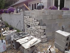 a brick wall is being built in front of a house