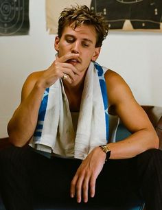 a man sitting on top of a couch wearing a scarf