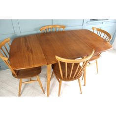 a wooden table with four chairs around it