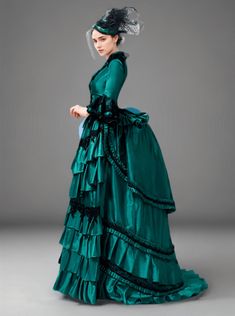 Step into a world of opulent beauty with our "Emerald Green Rococo Ball Gown," a lush tribute to Victorian flair and baroque extravagance. This gown is a work of art, where the vibrant emerald green fabric makes a bold statement of sophistication and style. Adorned with elegant black lace trim, each detail adds to the grandiose silhouette that harkens back to the majestic courts of the rococo era. The layered skirt, crafted with precision, falls in sumptuous folds, making it a perfect ensemble f Victorian Gothic Gown, Elegant Baroque Victorian Dress For Fancy Dress, Victorian Green Costume Dress, Elegant Baroque Costume Gown, Green Victorian Dress With Historical Design, Green Formal Dress With Historical Design, Formal Green Dress With Historical Design, 1800s Dresses Victorian Gowns, Elegant Baroque Gown For Costume Party