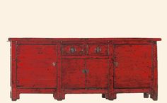 an old red wooden sideboard with four doors and two drawers on the bottom shelf