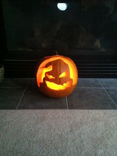 a carved pumpkin sitting on top of a tile floor