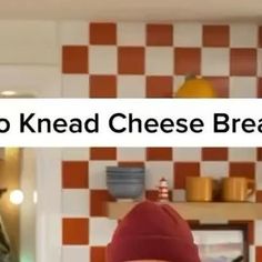 there is a sign that says no knead cheese bread on the wall in this kitchen