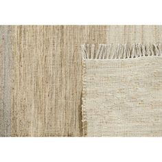 an area rug with two different colors and fringes on the bottom one is beige