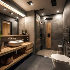 a bathroom with a sink, toilet and shower stall in the middle of the room