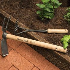 two garden tools are laying on the ground