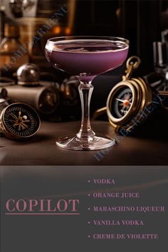 a purple cocktail in a coupe glass on a table with other items around it and the words copilot written below