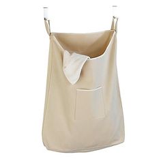 a white bag hanging on a clothes line with a pocket in the front that has a bow at the top