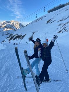 two people on skis posing for the camera