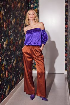 Make a bold statement with our Vibrant Purple Silk Off-the-Shoulder Top. This luxurious piece seamlessly blends comfort with high fashion. The off-the-shoulder design adds allure, while the vibrant purple hue exudes confidence. Elevate your wardrobe with this striking and versatile essential, perfect for making a lasting impression on any occasion. Pair with the coordinating Purple Long Slit Skirt for a long, lean look. Details: Fabric 100% Silk Satin Sizing: XS (0-2), S (4-6), M (8-10), L (12) Poet Blouse, Stocking Fillers For Her, Satin Pants, Vibrant Purple, Holiday Party Outfit, Purple Silk, Silk Pants, Purple Hues, Off The Shoulder Top