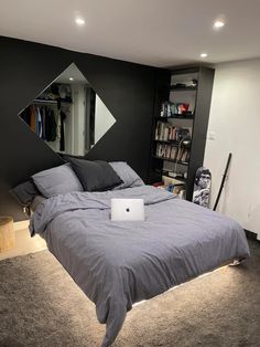 a laptop computer sitting on top of a bed in a room with carpeted floors