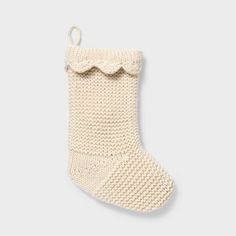 a white knitted stocking hanging from the side