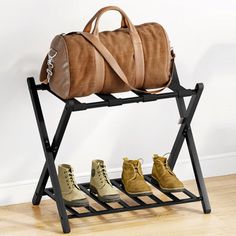 three pairs of shoes and a duffel bag on a rack