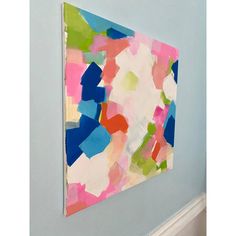 an abstract painting hangs on the wall