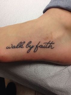 a woman's foot with the words walk by faith tattooed on it