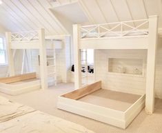 a room with bunk beds and white walls