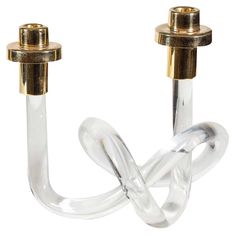 a pair of glass candlesticks with gold colored metal fittings on each end