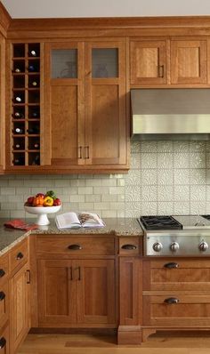 a kitchen with wooden cabinets and stainless steel stove top oven, dishwasher and wine rack