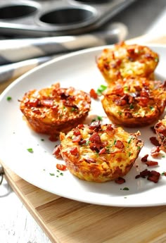 four bacon and cheese muffins on a white plate