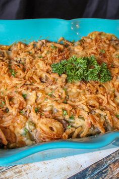 a casserole dish with mushrooms, cheese and parsley