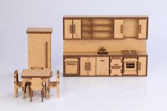 a toy kitchen with table and chairs next to it