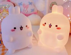 two white bunny lamps sitting on top of a table