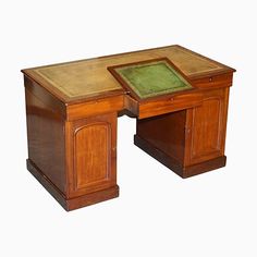 an old wooden desk with a green leather top and drawer on the bottom, against a white background