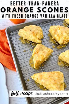 orange scones with fresh orange vanilla glaze on a cooling rack and an orange napkin