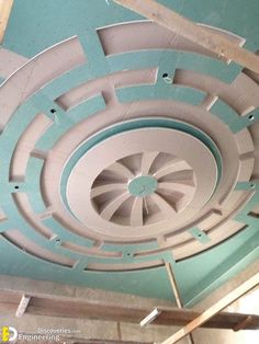 a ceiling fan in the middle of a room under construction