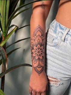 a woman's arm with a flower tattoo on it