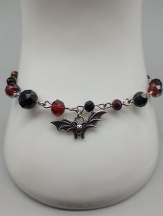 Two-toned color red/blue, purple, and black  faceted glass beads. Silver color alloy bat charm. Adjustable chain and lobster clasp closure. Stainless steel silver color. Set of 1. Vampire Bat, Faceted Glass, Pretty Jewellery, Lebanon, Color Set, Purple And Black, Blue Purple, Lobster Clasp, Red Color