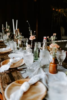 the table is set with wine glasses, plates and napkins for an elegant dinner