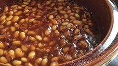 a pot filled with beans sitting on top of a stove