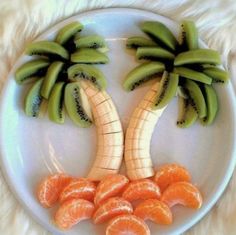 a white plate topped with sliced oranges and banana's on top of each other