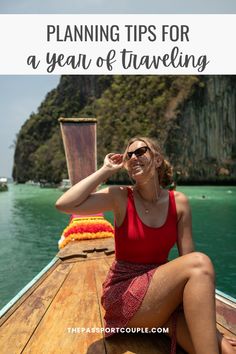 a woman sitting on the bow of a boat with text overlay reading planning tips for a year of traveling