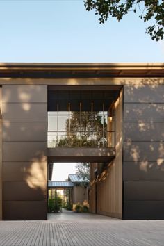 an entrance to a modern home with large windows