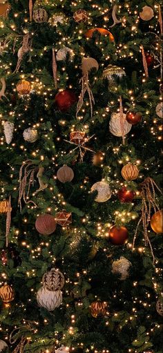 a christmas tree is decorated with ornaments and lights